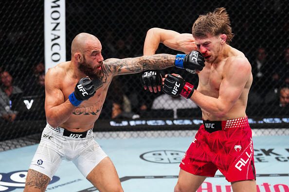 Jean Silva of Brazil strikes Arnold Allen of England in a featherweight bout dur